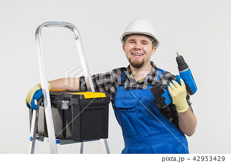 Portrait of handsome happy builder with skrewdriver on white background Portrait of handsome happy builder with skrewdriver on white background 42953429