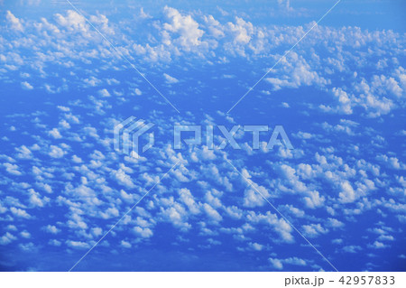Aerial birds eye view above clouds of the blue sky 42957833