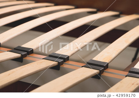 Close-up wooden elements of an arthopedic base of a double bed. Interior structure of furniture 42959170
