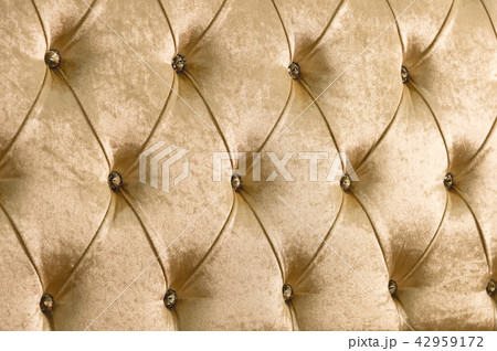 Beige soft textile background with symmetrical buttons on the corners of diamonds. Soft and 42959172