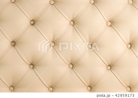 Beige soft tapestry pattern background with symmetrical buttons on the corners of diamonds. Soft and 42959173