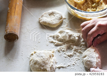 Formed raw potato pie in female hands Formed raw potato pie in female hands 42959283