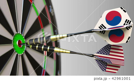 Flags of South Korea and the USA on darts hitting bullseye of the target. International cooperation Flags of South Korea and the USA on darts hitting bullseye of the target. International cooperation 42961001