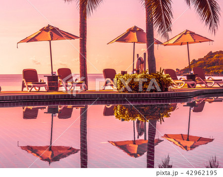 Umbrella and chair around luxury outdoor swimming pool Umbrella and chair around luxury outdoor swimming pool 42962195