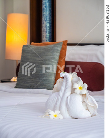 White elephant towel and comfortable pillow on bed White elephant towel and comfortable pillow on bed 42963163