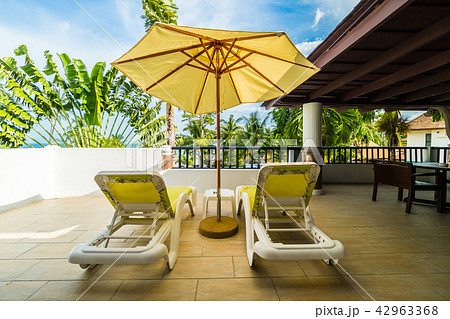 Umbrella and chair on outdoor patio with beautiful view 42963368