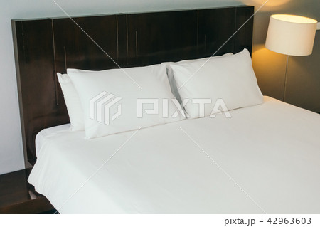 White comfortable pillow on bed 42963603
