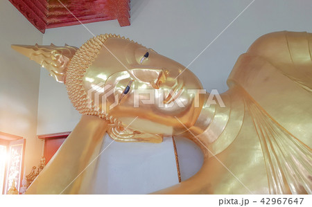 Golden Buddha in a sleeping posture. 42967647