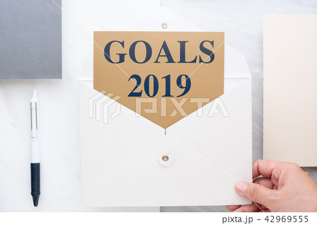 hand holding white envelop with goals 2019 hand holding white envelop with goals 2019 42969555