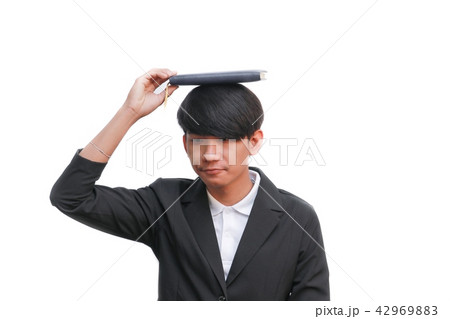 student with book on head against white background student with book on head against white background 42969883