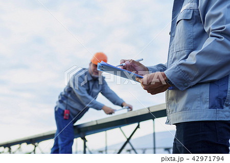 Engineers are checking the solar panel maintenance Engineers are checking the solar panel maintenance 42971794