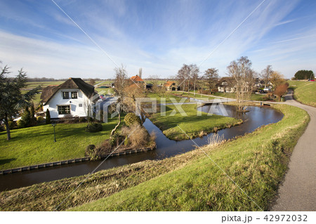 Dutch polder landscape with a farm and some houses 42972032