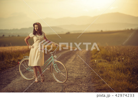 pretty young smilling woman with retro bicycle in pretty young smilling woman with retro bicycle in 42974233