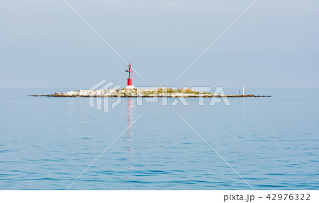 Light beacon on the small island 42976322
