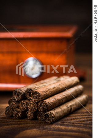 Cuban cigars with humidor in background Cuban cigars with humidor in background 42976949