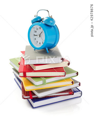 notebooks and alarm clock at white background 42978676