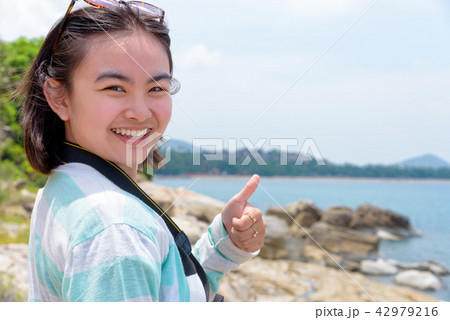 Young woman photography near the sea 42979216