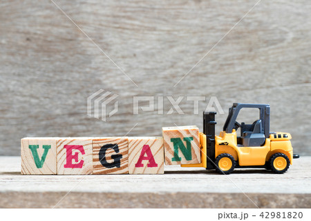 Toy forklift hold letter block n to word vegan 42981820