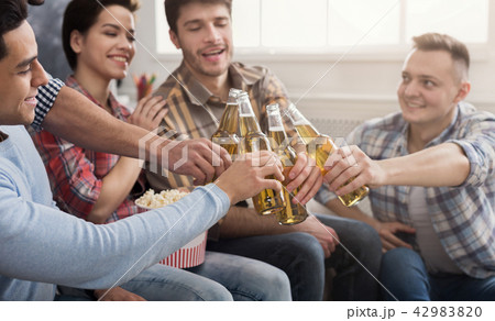 Happy young friends clinking beer bottles 42983820