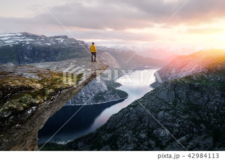 Alone tourist on Trolltunga rock Alone tourist on Trolltunga rock 42984113