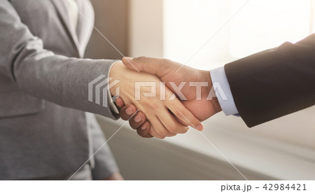 Business man and woman shaking hands Business man and woman shaking hands 42984421