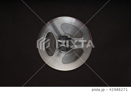 Spinning reel of tape recorder on black background 42986271