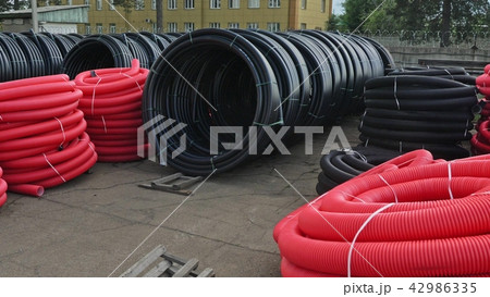 Warehouse of finished plastic pipes industrial outdoors storage site. Manufacture of plastic water 42986335