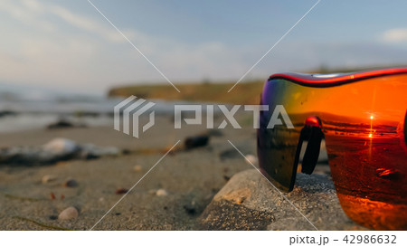 Sun glasses at sunset. Reflection of the sunset. Sun glasses at sunset. Reflection of the sunset. 42986632