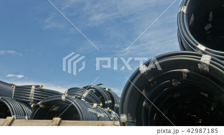 Warehouse of finished plastic pipes industrial outdoors storage site. Manufacture of plastic water Warehouse of finished plastic pipes industrial outdoors storage site. Manufacture of plastic water 42987185