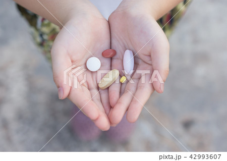 Small kid hands holding drug 42993607