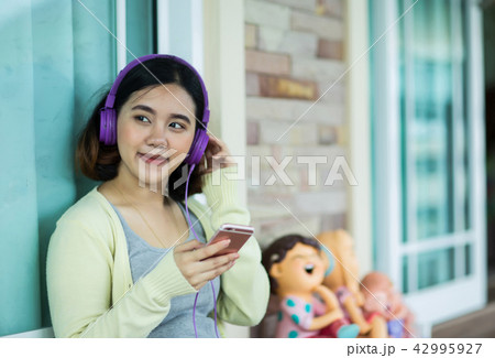 Young asian girl enjoy listening to music Young asian girl enjoy listening to music 42995927