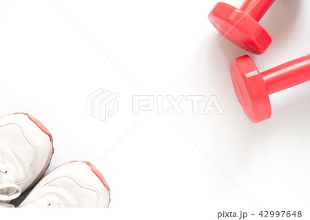 Creative flat lay with sport shoes and dumbbells Creative flat lay with sport shoes and dumbbells 42997648