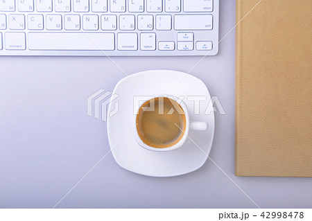 office table with notebook, keyboard cup of coffee 42998478