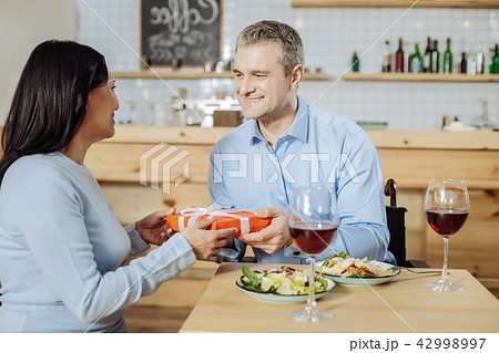 Handsome man giving a gift to a lady 42998997