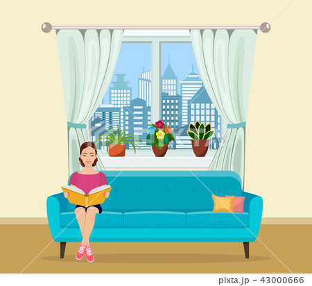 Young woman relaxing on sofa reading book at home 43000666