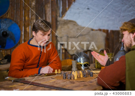 Two men playing popular strategy board game - tafl Two men playing popular strategy board game - tafl 43000883