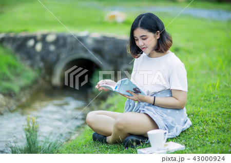 Asian girl reading a book in the garden 43000924