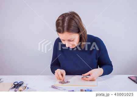 Designer making handmade brooch Designer making handmade brooch 43001025