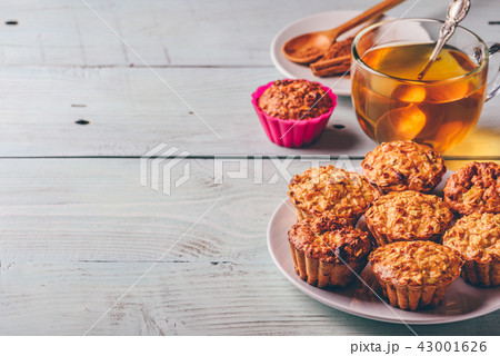 Oatmeal muffins with cup of green tea. 43001626