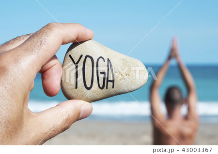 yogi man and text yoga in a stone 43003367