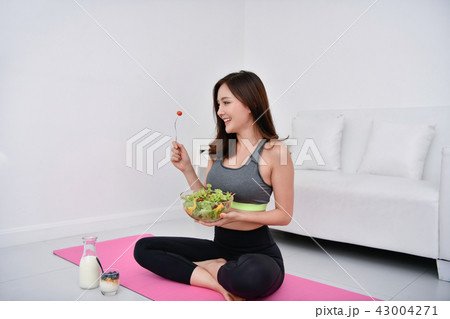 The concept of nutritional food. Beautiful girl takes care of he 43004271