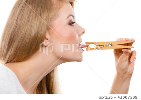 Blonde woman having tongue in clothespin Blonde woman having tongue in clothespin 43007509