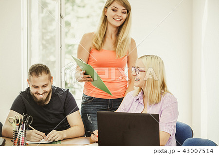 Students and teacher tutor in classroom 43007514