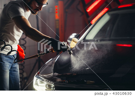 Car wash and coating business with ceramic coating.Spraying varnish to car. Car wash and coating business with ceramic coating.Spraying varnish to car. 43010630