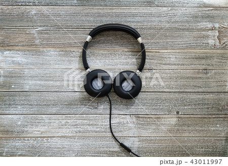Headphones on a wooden desk 43011997