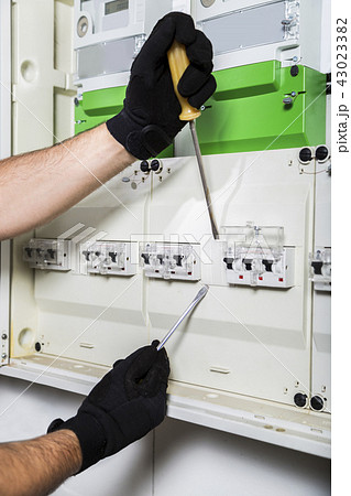 Electrician repairs distribution board close up Electrician repairs distribution board close up 43023382