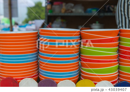 Many dishware stacked on table In the kitchen 43039407
