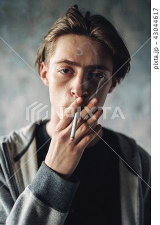 Young man smoke cigarette, addiction concept Young man smoke cigarette, addiction concept 43044617