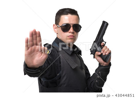 Seriuse cop in sunglasses poses with gun Seriuse cop in sunglasses poses with gun 43044851