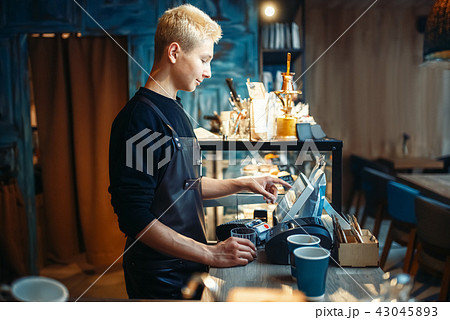 Barista hand pours beverage from coffee machine 43045893